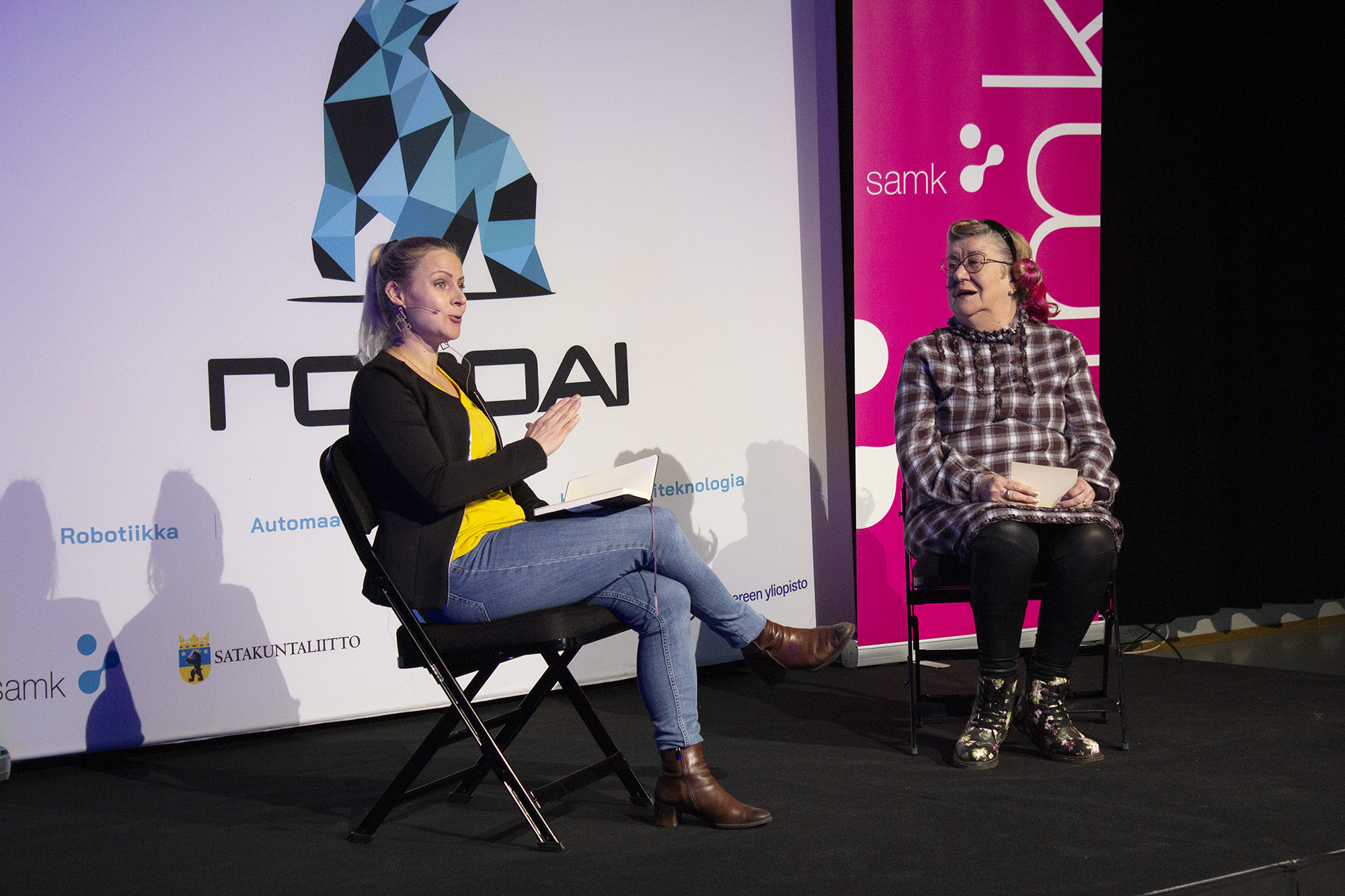 On the RoboAI week stage Sari Merilampi and Sorjo Mäkipää.