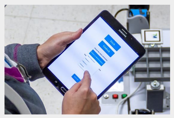 A person choosing something with a tablet.