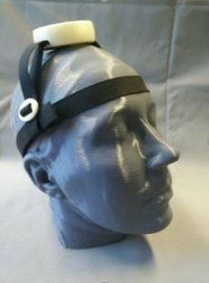 The picture shows a 3D-printed head with a head controller attached.
