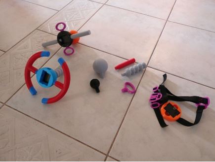 The picture shows a variety of hand controllers on the floor, with numerous ways of gripping.