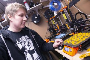 Researcher Joonas Kortelainen presents a plastic extruder printer.