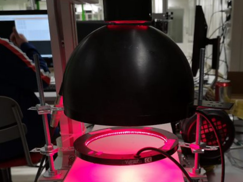 The picture shows a lighting solution with a large black diffuse dome roll that produces pink light.