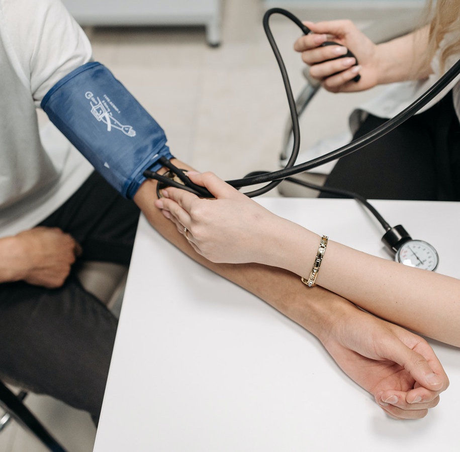 A nurse is measuring blood pressure from a patient. 