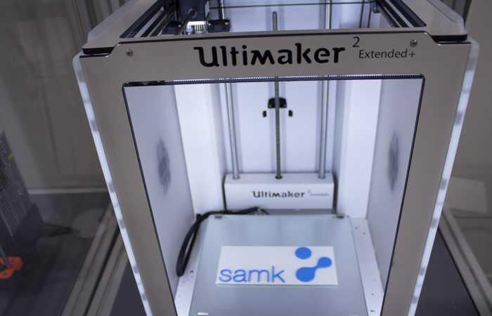 Closeup of a 3D printer with SAMK logo inside. 