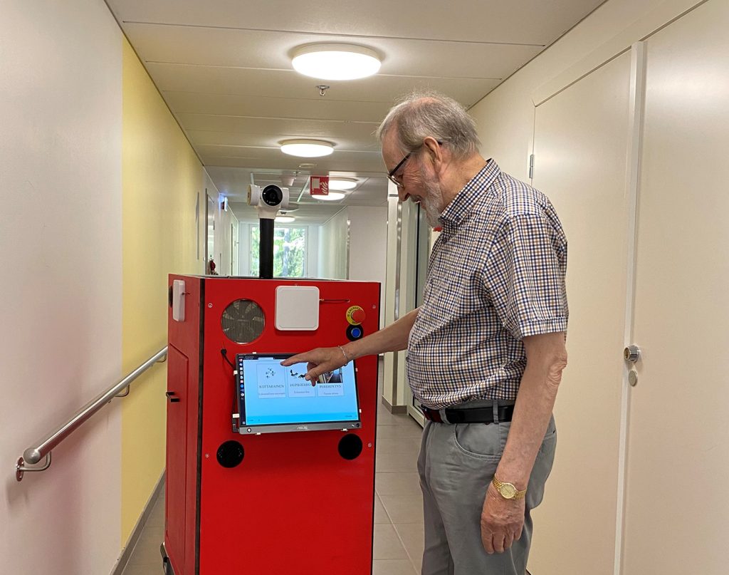 A man is using a mobile robot.