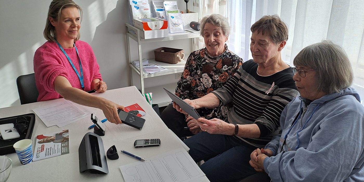 Three seniors experimenting with technology.