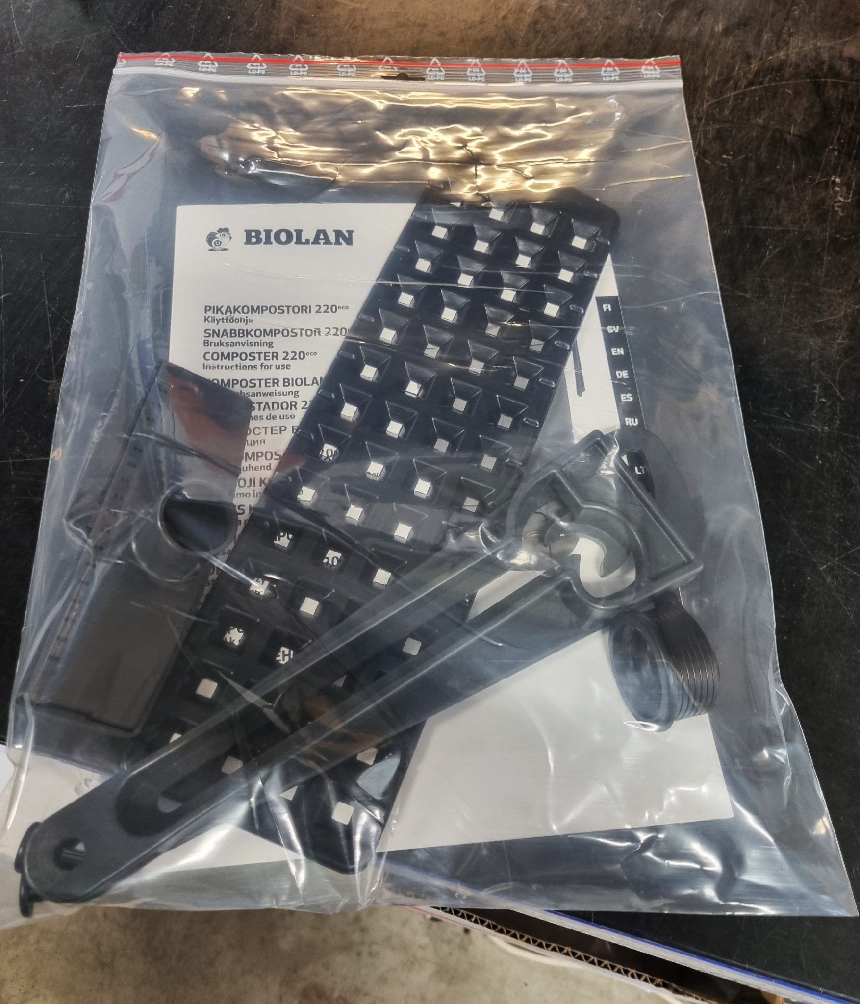 A close-up of a plastic bag with black pieces inside.