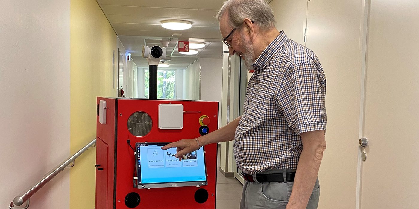 A man is using a mobile robot.