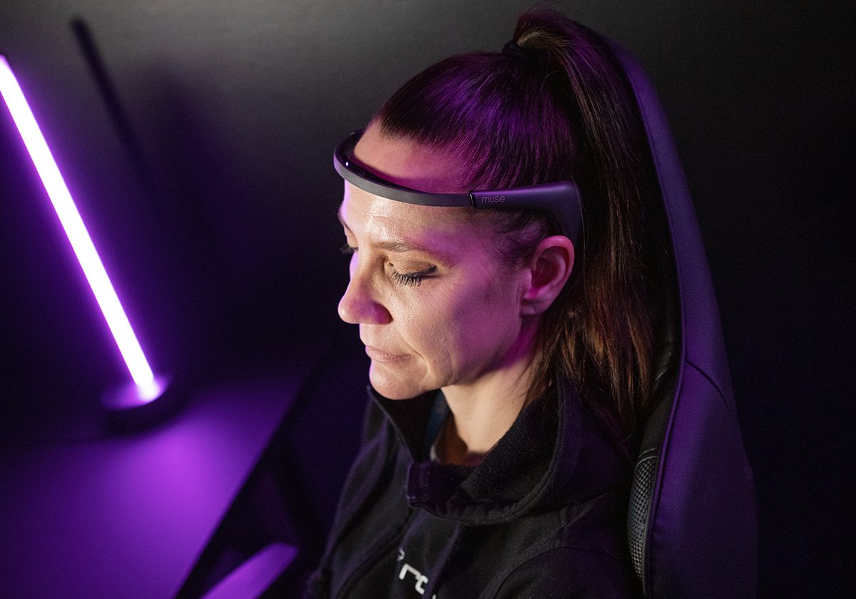 The woman has an EEG brain waveform measuring device on her head.