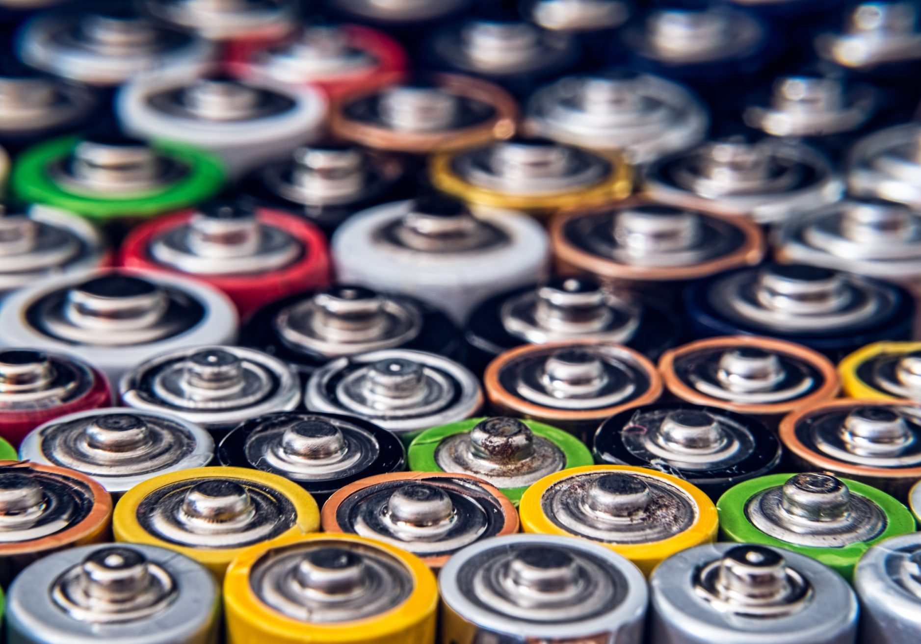 Batteries of different colours side by side, illustration.